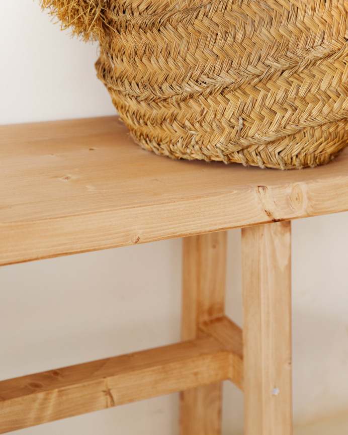 Solid wood stool in a medium oak tone, measuring 100x50cm.