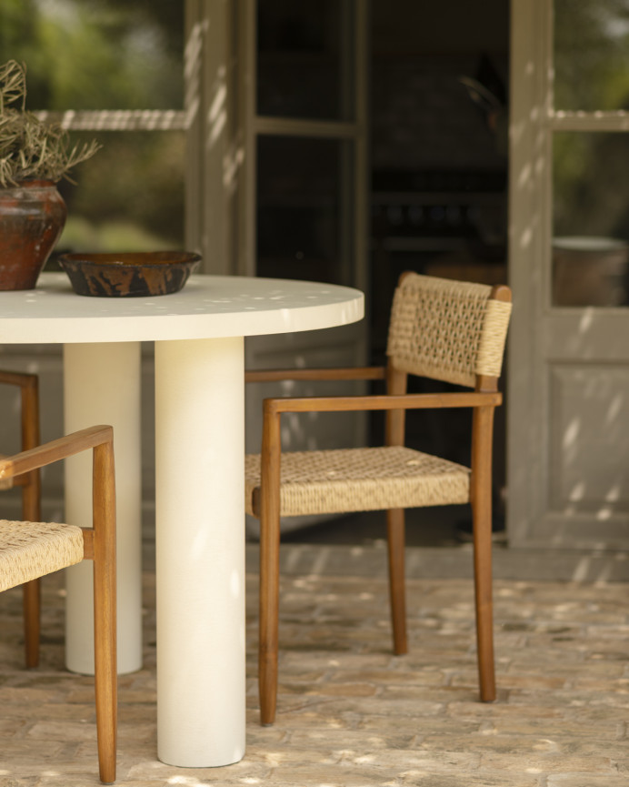 Round dining table made of microcement in off-white tone, available in various sizes.