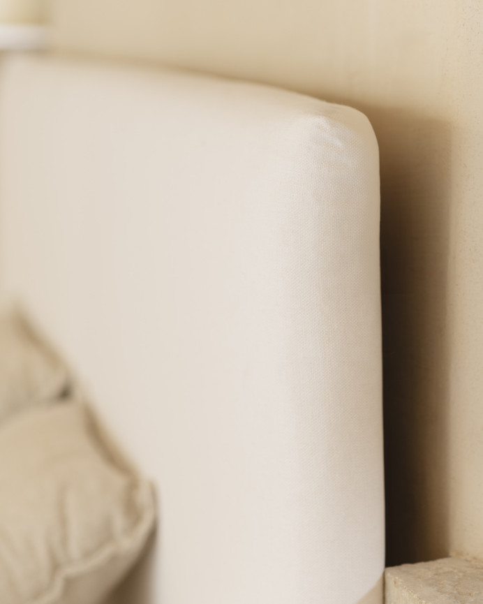 Upholstered bed covered in white linen for a mattress of various sizes