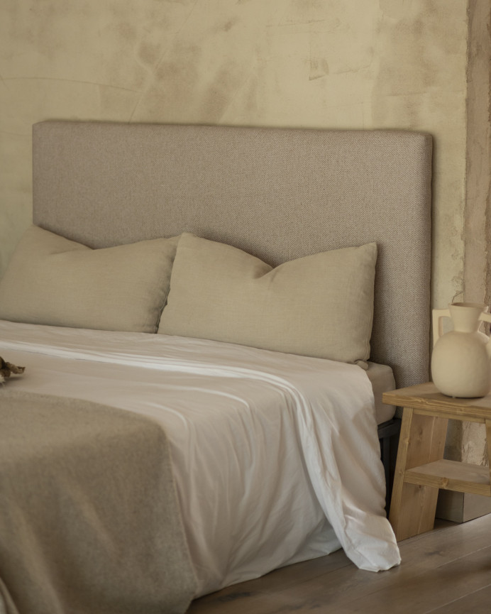 Upholstered headboard in light brown color available in various sizes.