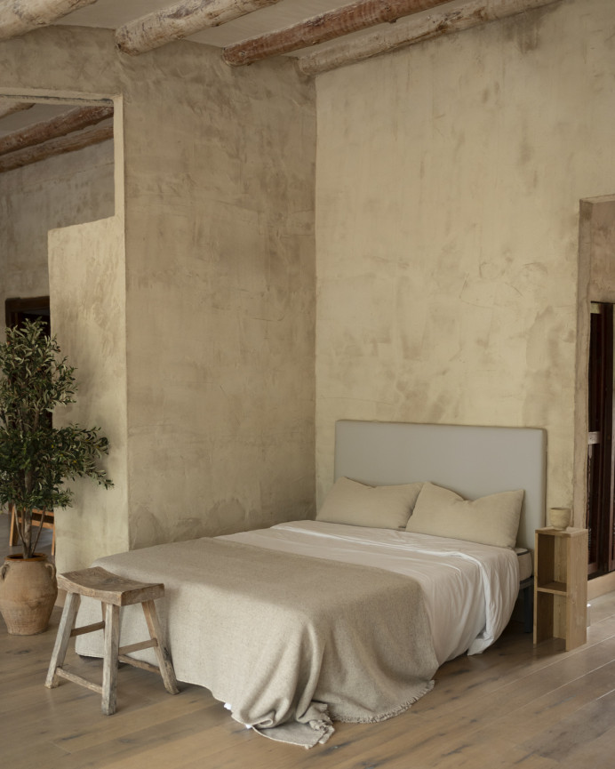 Upholstered headboard in light gray color available in various sizes.