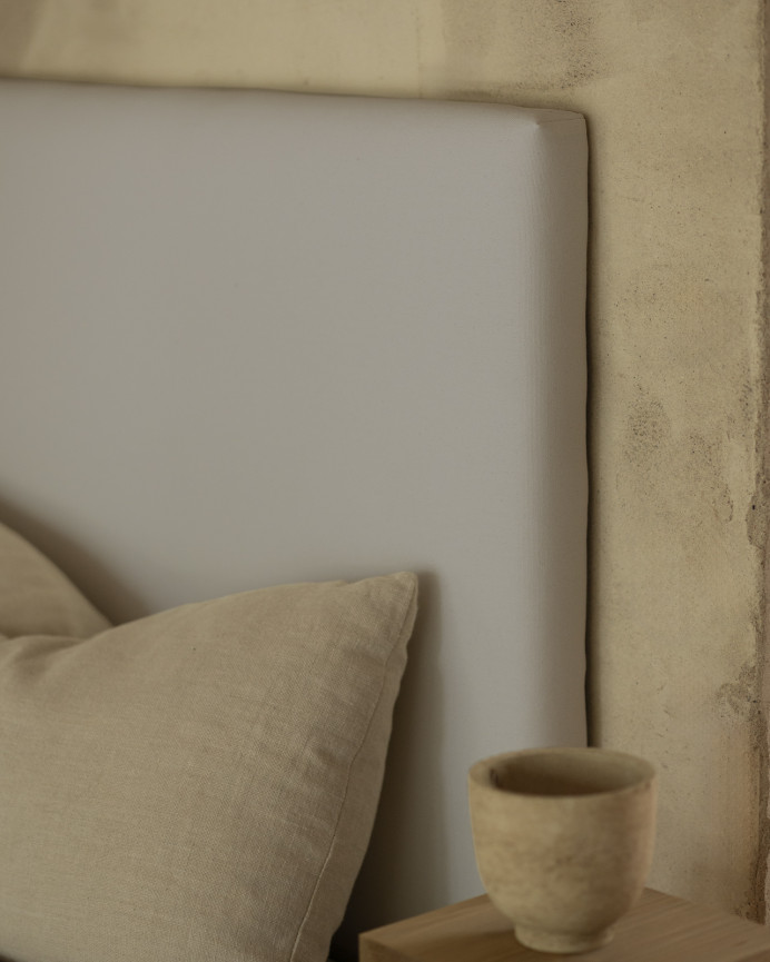 Upholstered headboard in light gray color available in various sizes.