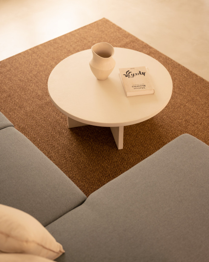 Round microcement coffee table in off-white shade available in various sizes.