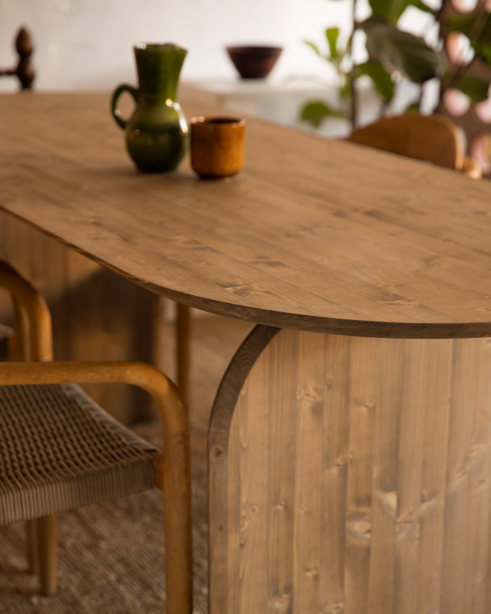 Oval solid wood dining table in dark oak tone of various sizes.