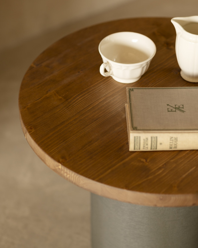 Round solid wood coffee table in dark oak tone with green micro cement leg in various sizes