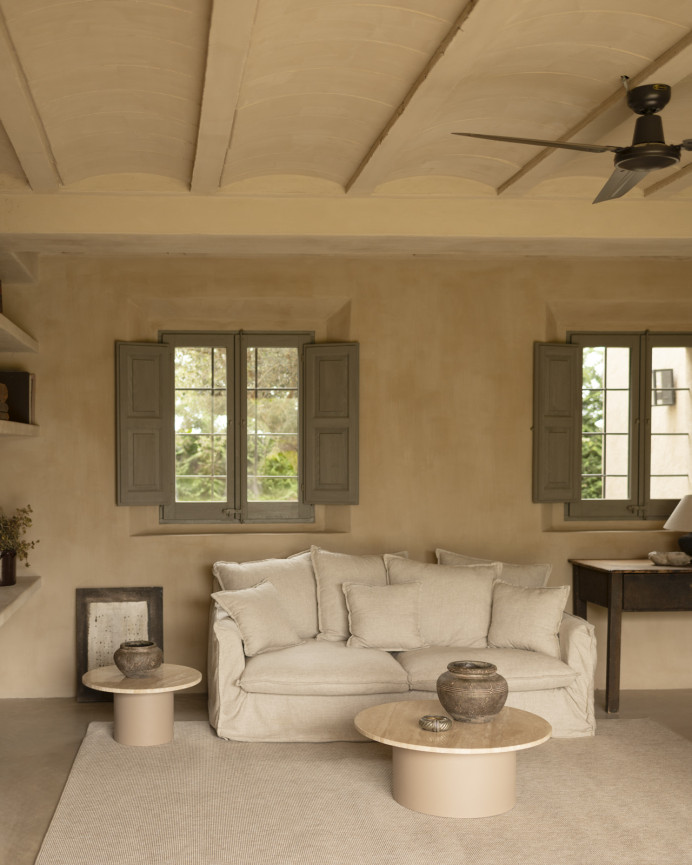 Round travertine marble coffee table with beige micro cement legs, measuring 80x32cm.