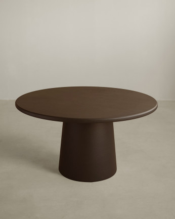 Round dining table made of brown microcement in various sizes