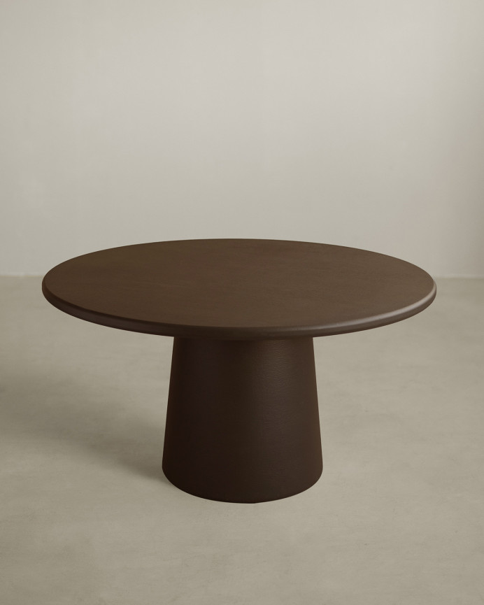 Round dining table made of brown microcement in various sizes