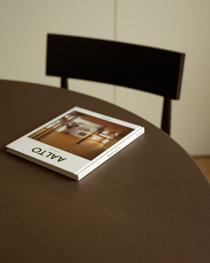 Round dining table made of brown microcement in various sizes