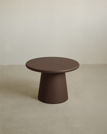 Round coffee table made of microcement in brown tones available in various sizes.