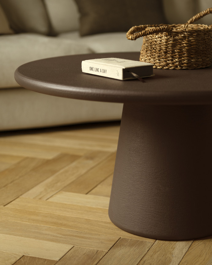 Round coffee table made of microcement in brown tones available in various sizes.