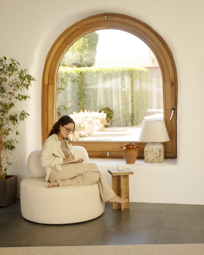 Round white boucle armchair measuring 91x71cm.