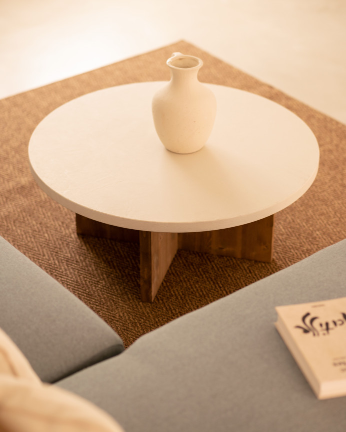Round microcement coffee table in off-white tone with dark oak wood legs in various sizes.