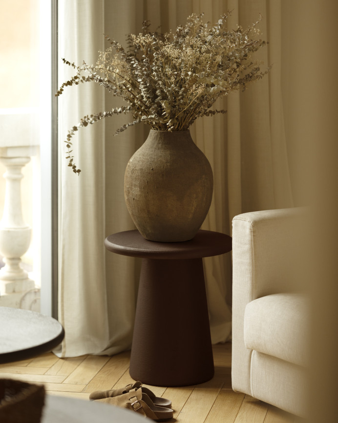 Round brown microcement side table measuring 45x50cm