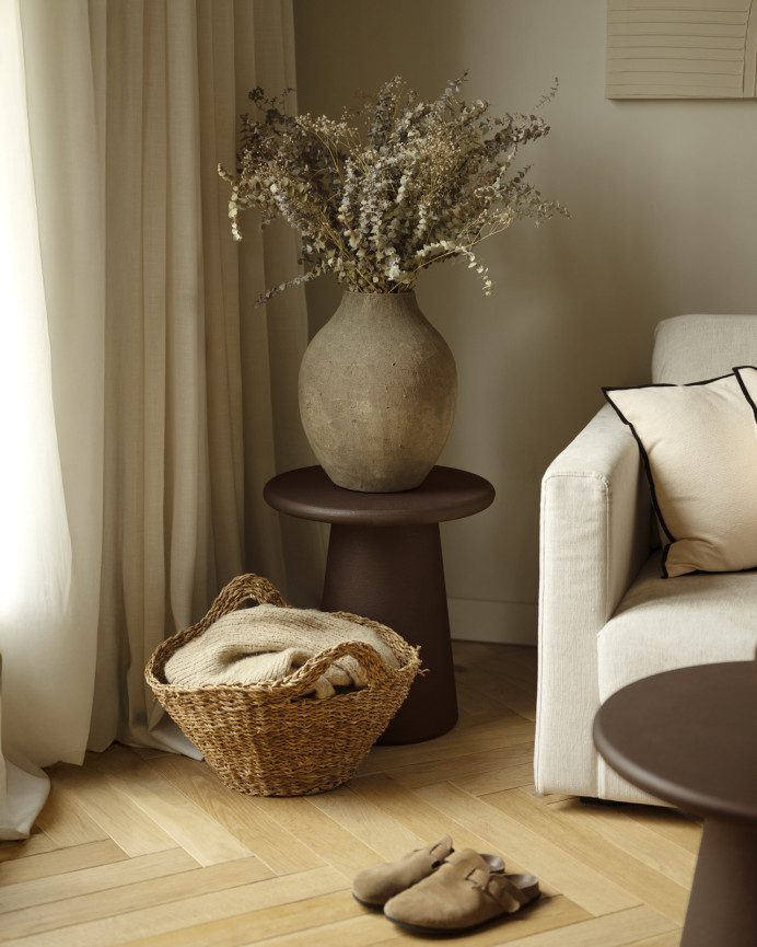 Round brown microcement side table measuring 45x50cm