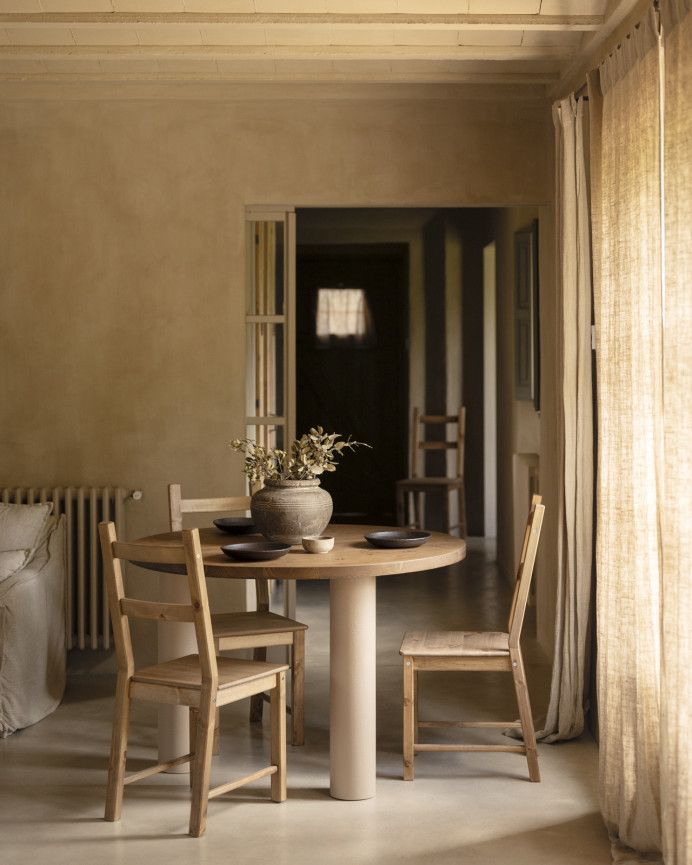 Round solid oak wood dining table with dark oak tone and earth-tone microcement legs available in various sizes.