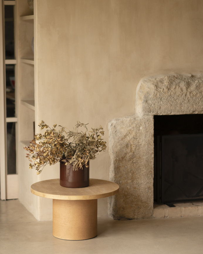 Round solid wood coffee table in a medium oak tone and terracotta microcement leg in various sizes.