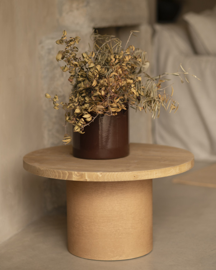 Round solid wood coffee table in a medium oak tone and terracotta microcement leg in various sizes.