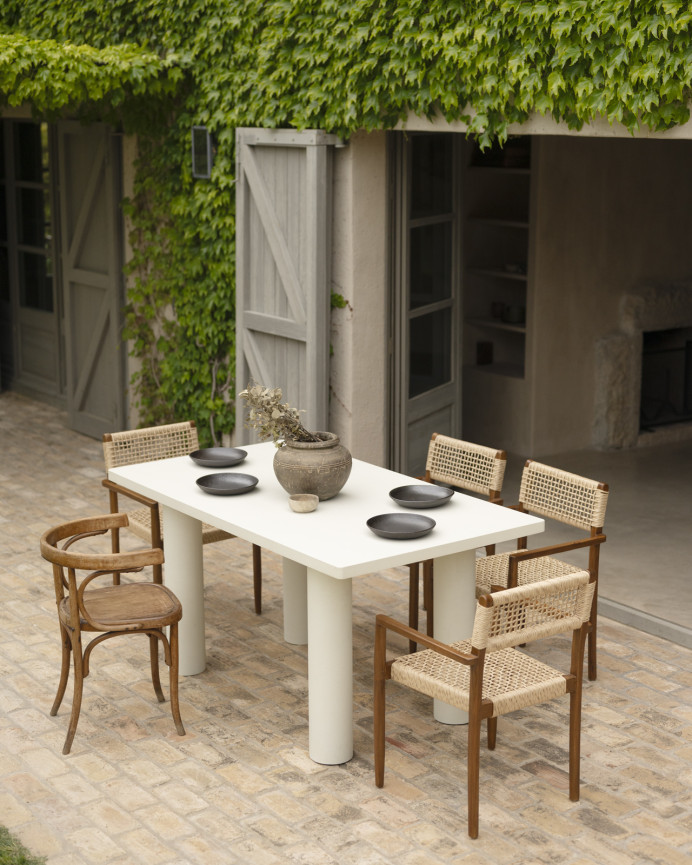 Rectangular dining table made of microcement in an off-white tone, available in various sizes.