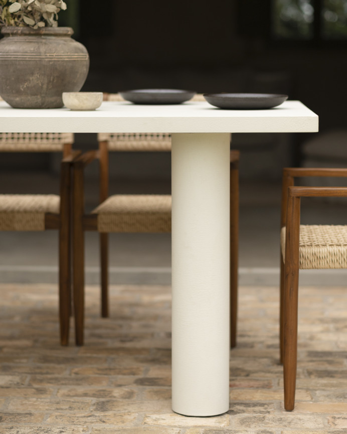 Rectangular dining table made of microcement in an off-white tone, available in various sizes.