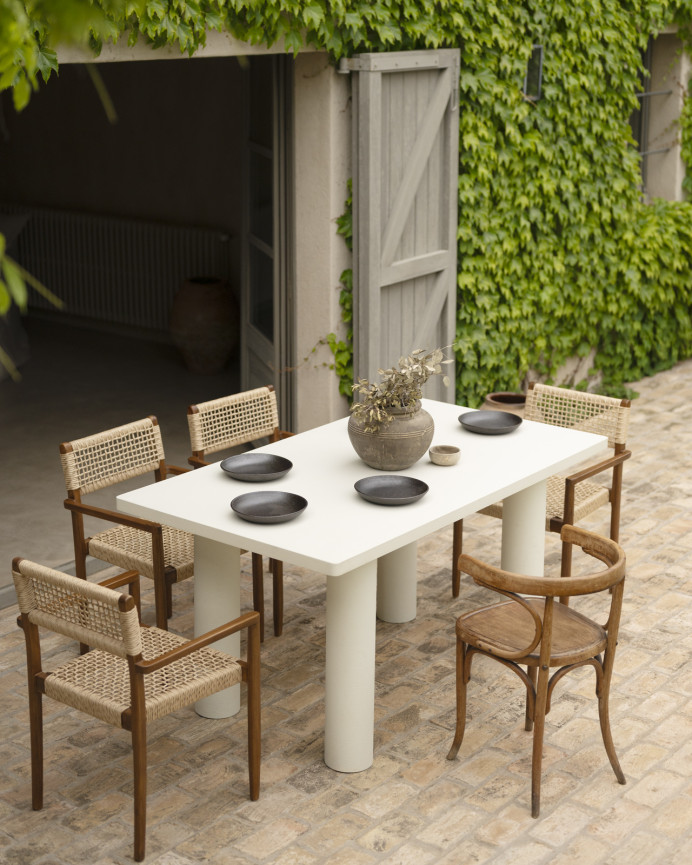 Rectangular dining table made of microcement in an off-white tone, available in various sizes.