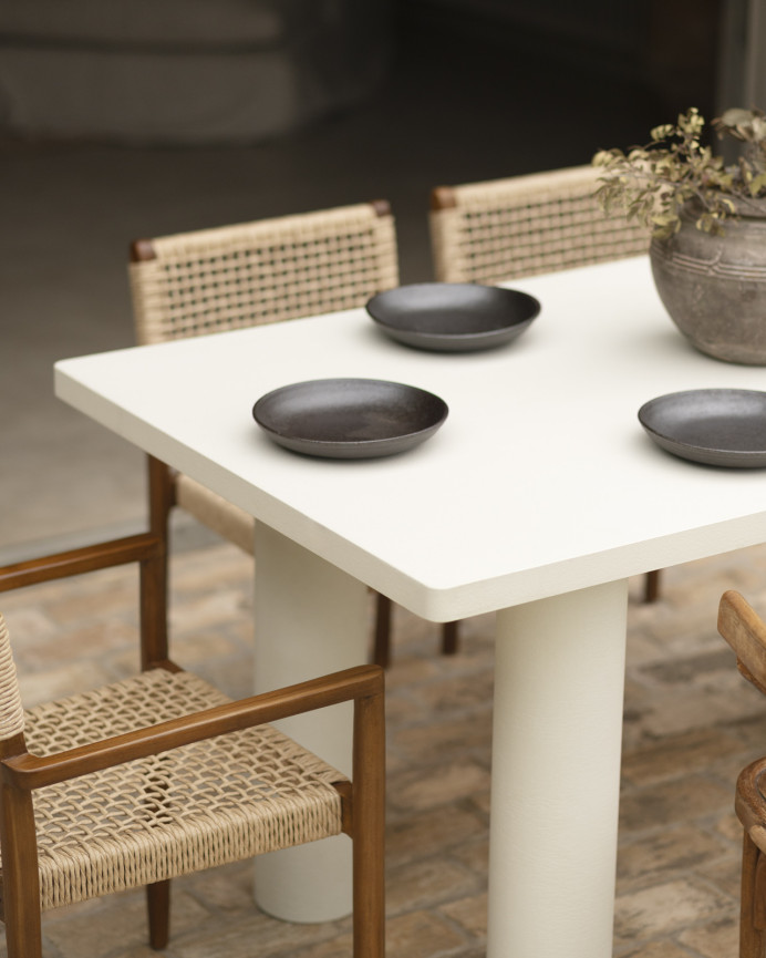 Rectangular dining table made of microcement in an off-white tone, available in various sizes.