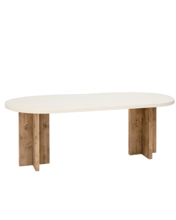 Oval dining table made of microcement in a light off-white tone with dark oak wood legs of various sizes.