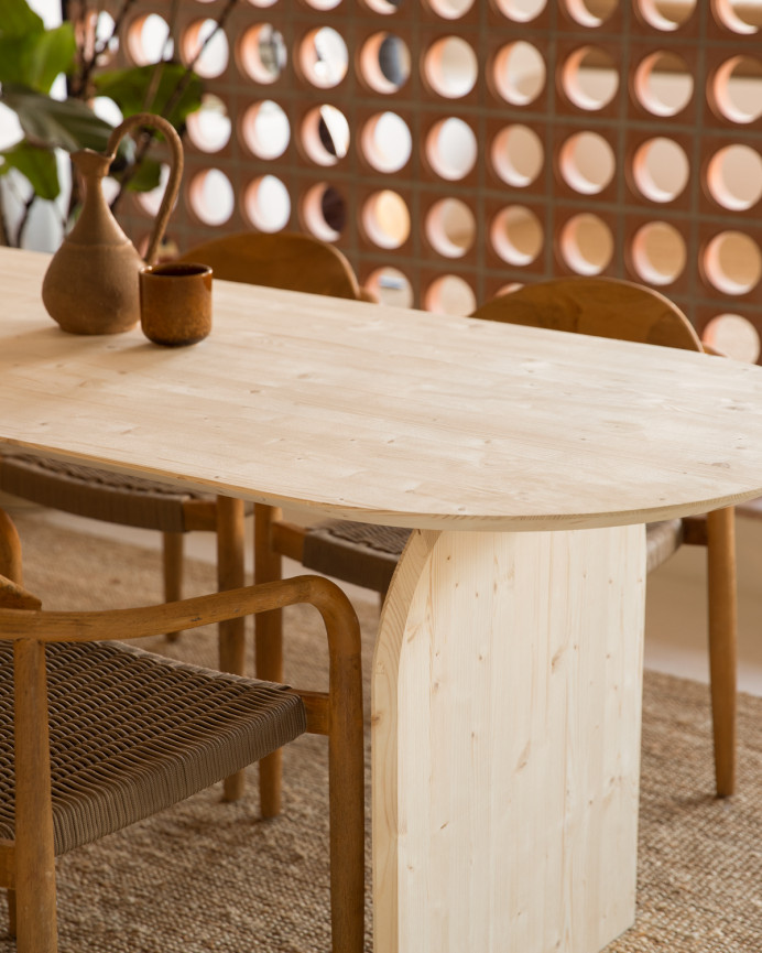 Oval solid wood dining table in natural tone in various sizes.