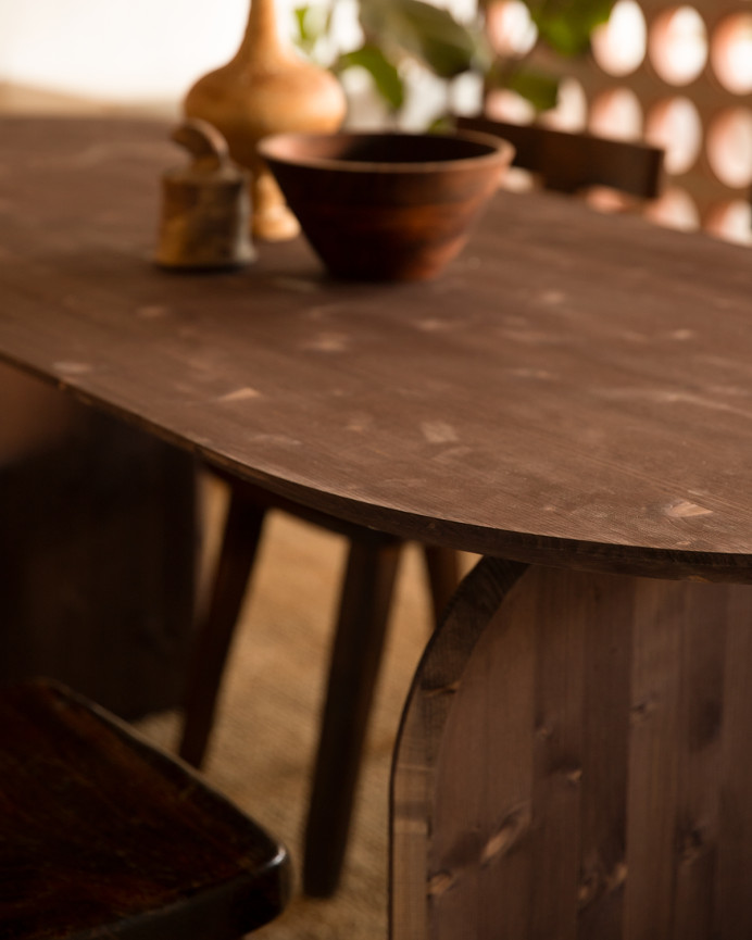 Oval solid wood dining table in walnut tone, available in various sizes.