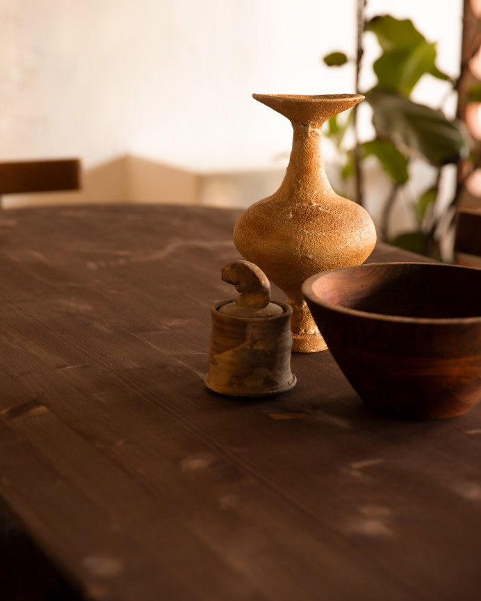 Oval solid wood dining table in walnut tone, available in various sizes.