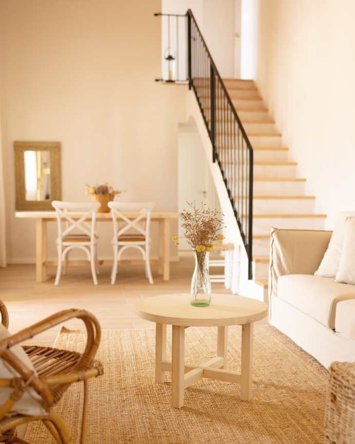 Round solid wood coffee table with natural finish available in various sizes.