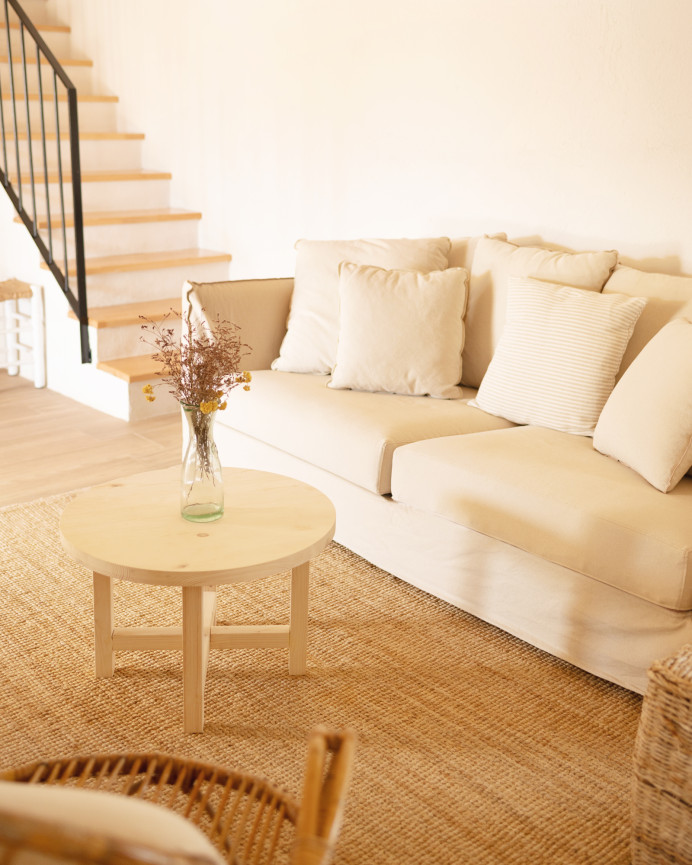 Round solid wood coffee table with natural finish available in various sizes.