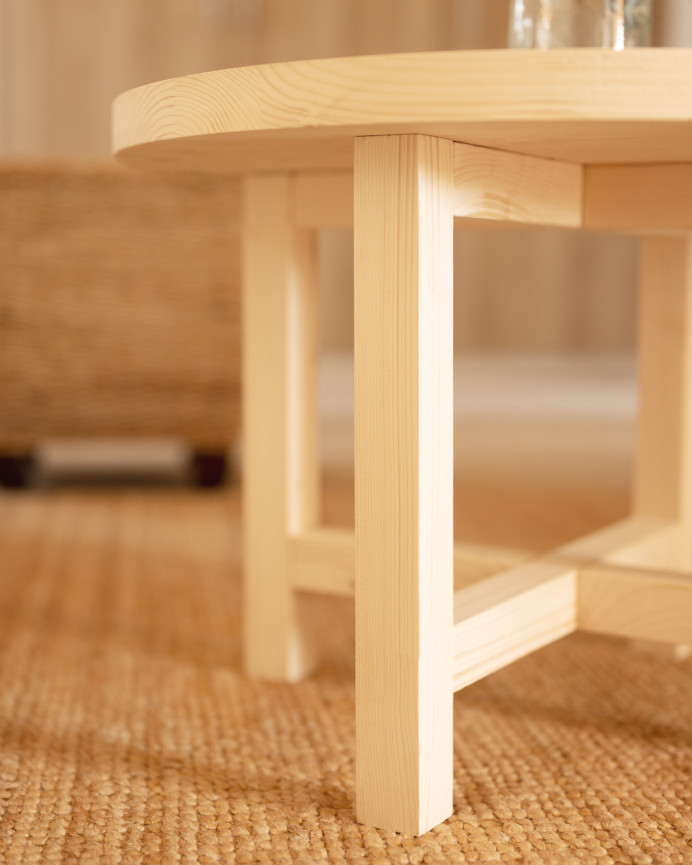 Round solid wood coffee table with natural finish available in various sizes.