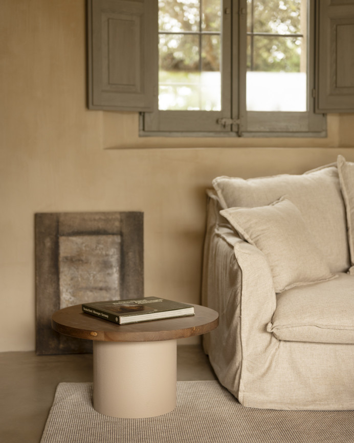 Round solid wood coffee table in a dark oak tone with a earth-tone microcement leg, available in various sizes.