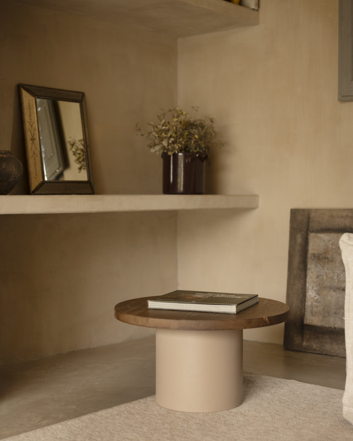 Round solid wood coffee table in a dark oak tone with a earth-tone microcement leg, available in various sizes.