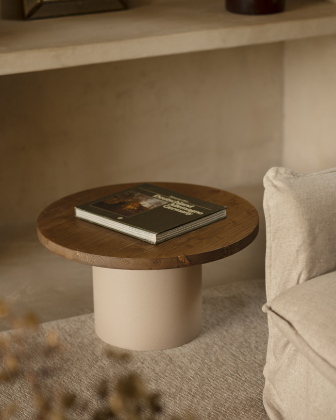 Round solid wood coffee table in a dark oak tone with a earth-tone microcement leg, available in various sizes.