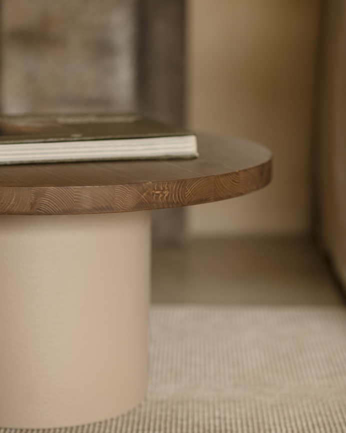 Round solid wood coffee table in a dark oak tone with a earth-tone microcement leg, available in various sizes.