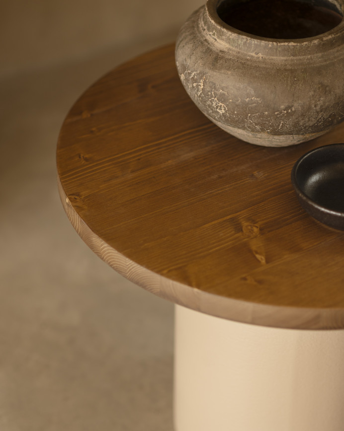 Round solid wood coffee table in a dark oak tone with a earth-tone microcement leg, available in various sizes.