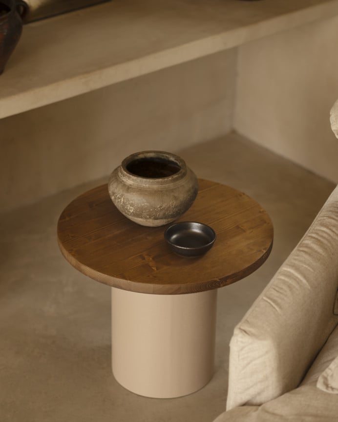 Round solid wood coffee table in a dark oak tone with a earth-tone microcement leg, available in various sizes.