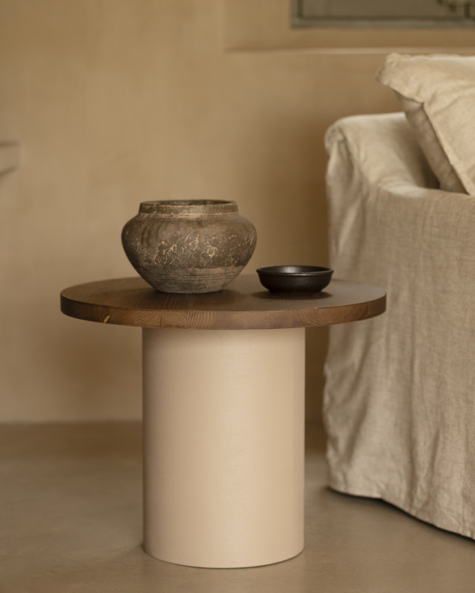Round solid wood coffee table in a dark oak tone with a earth-tone microcement leg, available in various sizes.