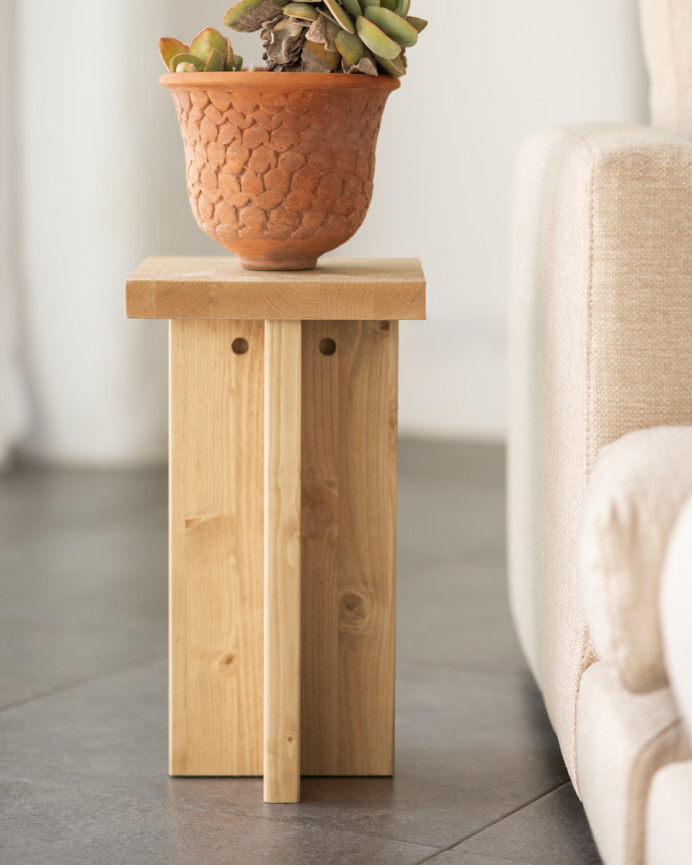 Solid wood side table in a medium oak tone measuring 25x25cm.