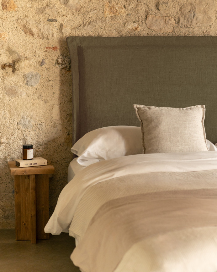 Upholstered green linen headboard with removable cover, available in various sizes.