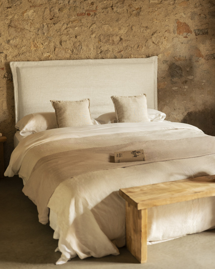 Upholstered headboard with removable white linen cover in various sizes.