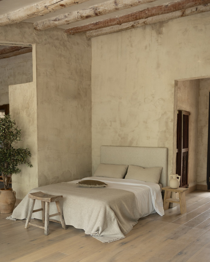 Upholstered headboard in beige color available in various sizes.