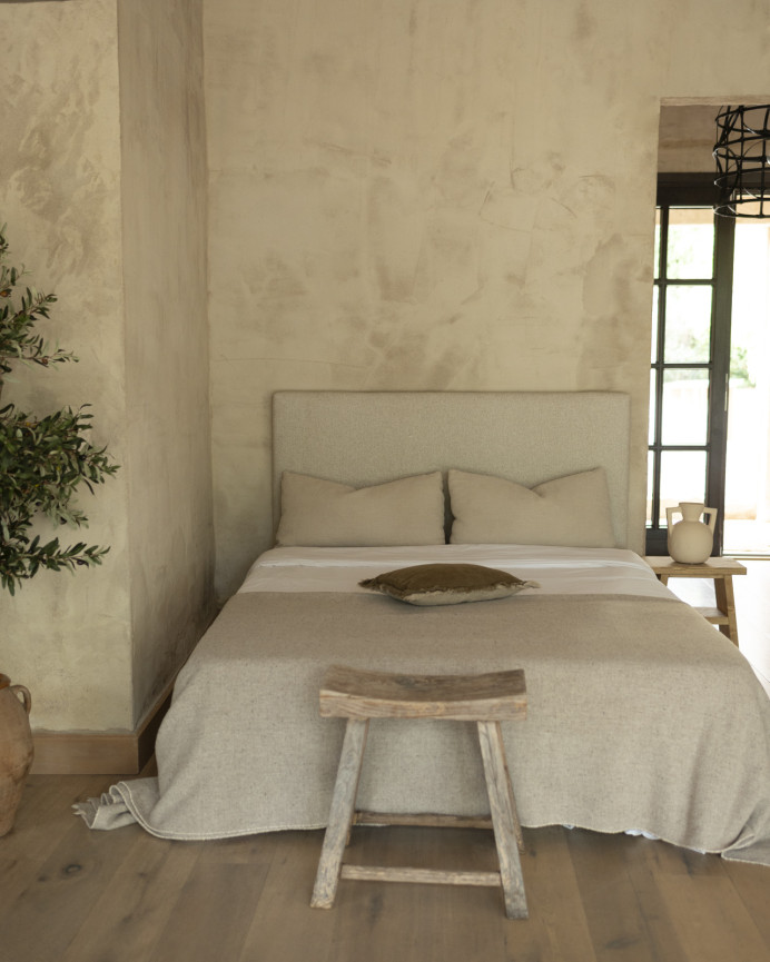 Upholstered headboard in beige color available in various sizes.