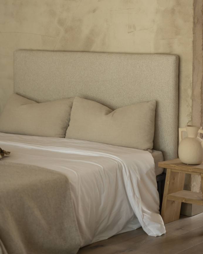 Upholstered headboard in beige color available in various sizes.