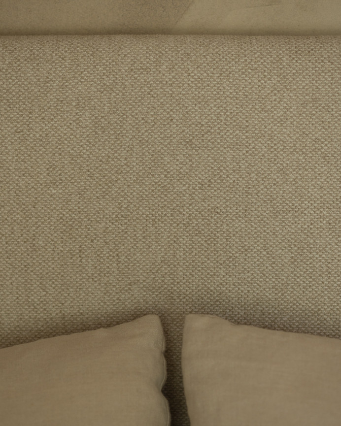 Upholstered headboard in beige color available in various sizes.