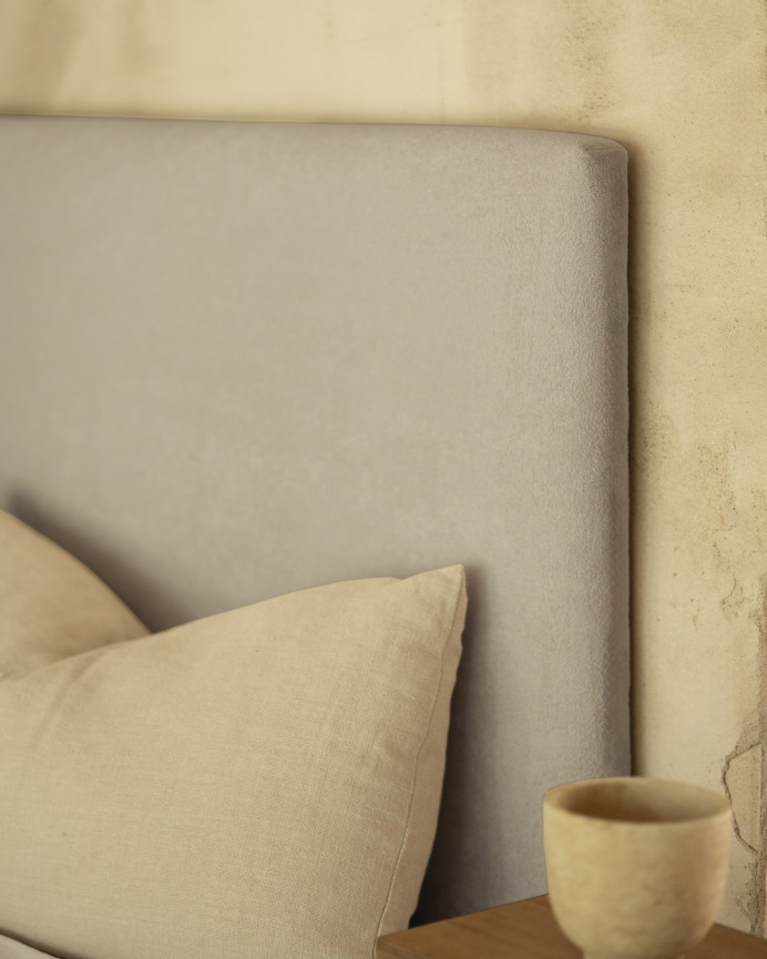 Upholstered headboard in light gray color available in various sizes.