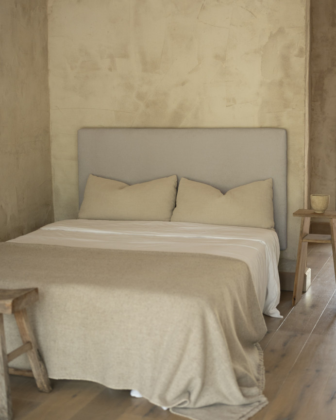 Upholstered headboard in light gray color available in various sizes.