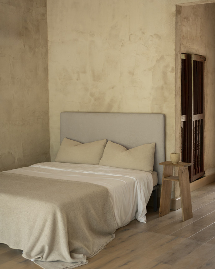 Upholstered headboard in light gray color available in various sizes.